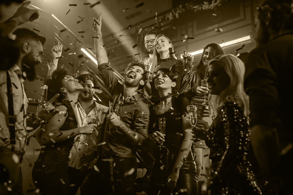 Group of energetic young people dancing at a party in a nightclub